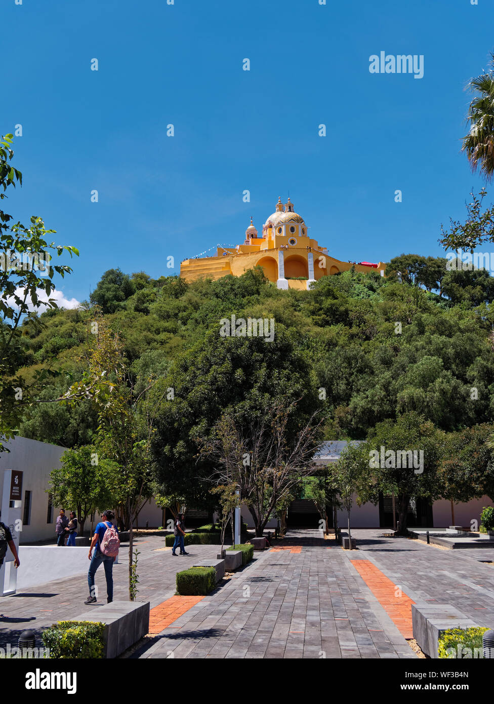 San Andres Cholula, Mexico, September 30, 2018 - Beautiful Shrine of Our Lady of Remedies sanctuary with people in Regional Museum at sunny day with blue sky. Stock Photo