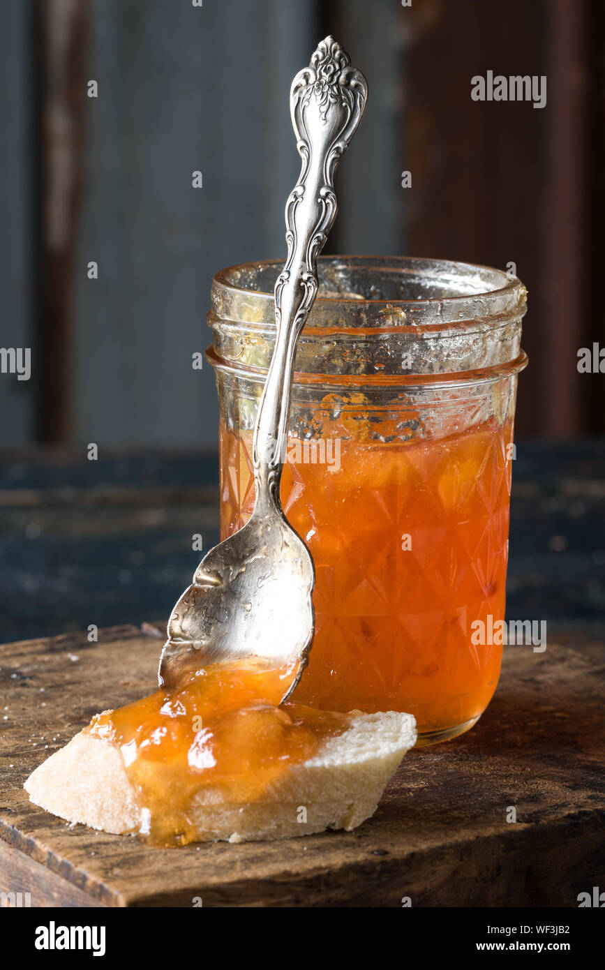Close-up Of Homemade Preserves In Jar On Cutting Board Stock Photo