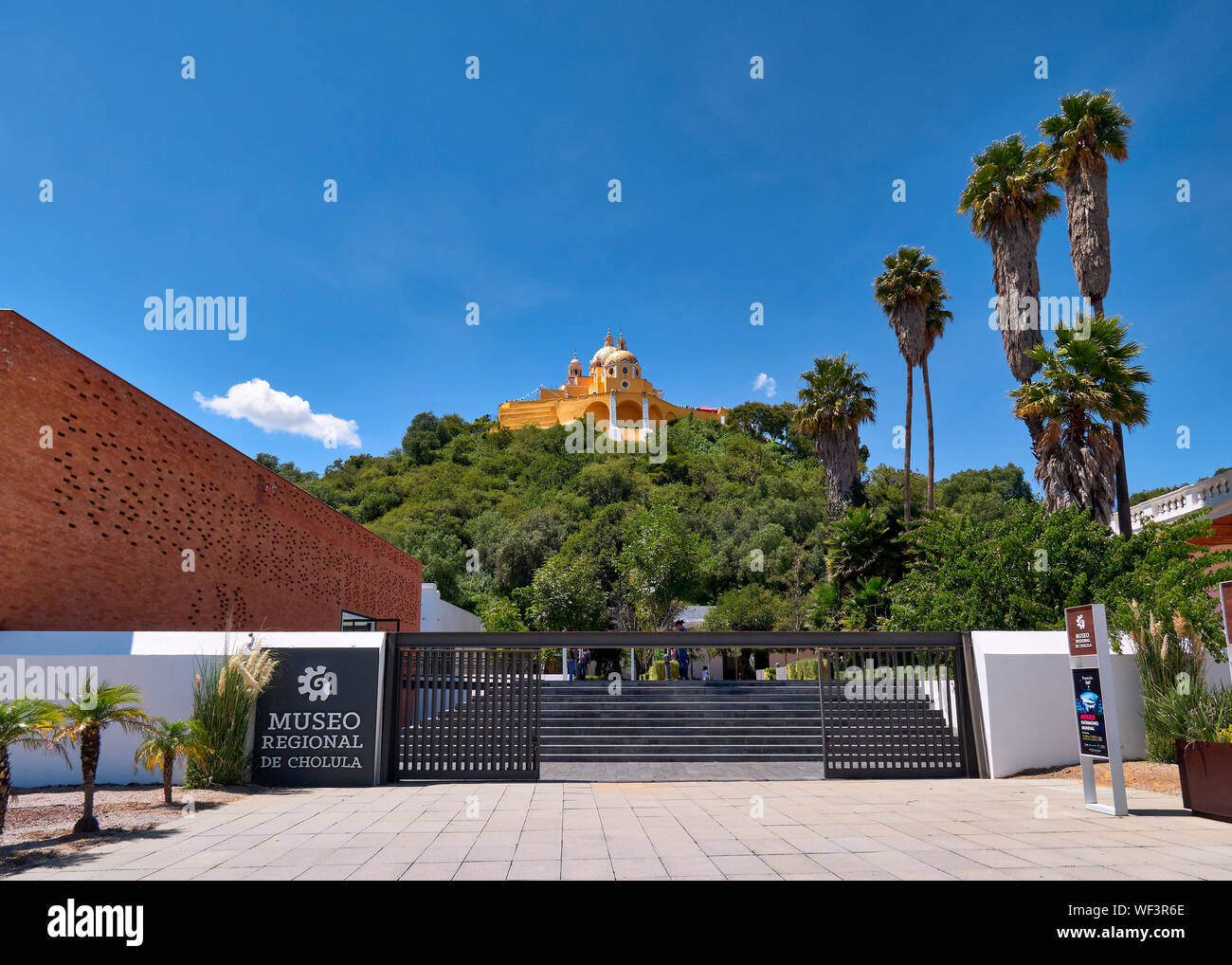 San Andres Cholula, Mexico, September 30, 2018 - Beautiful Shrine of Our Lady of Remedies sanctuary and Regional Museum at sunny day with blue sky. Stock Photo
