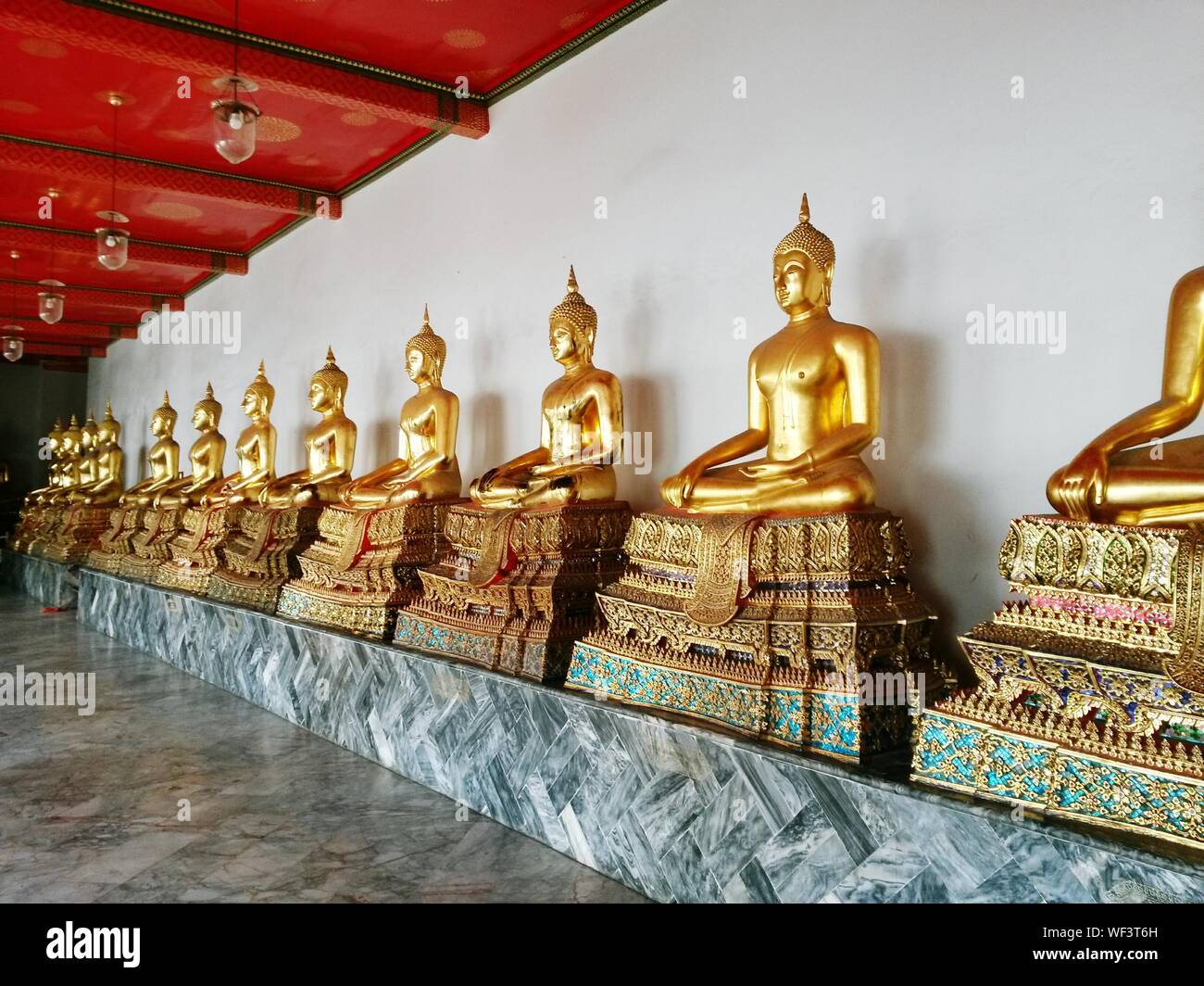 Golden Buddha Statue In Row At Wat Po Temple Stock Photo