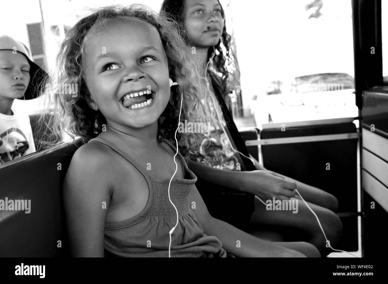 Happy Children Sitting In Vehicle Stock Photo