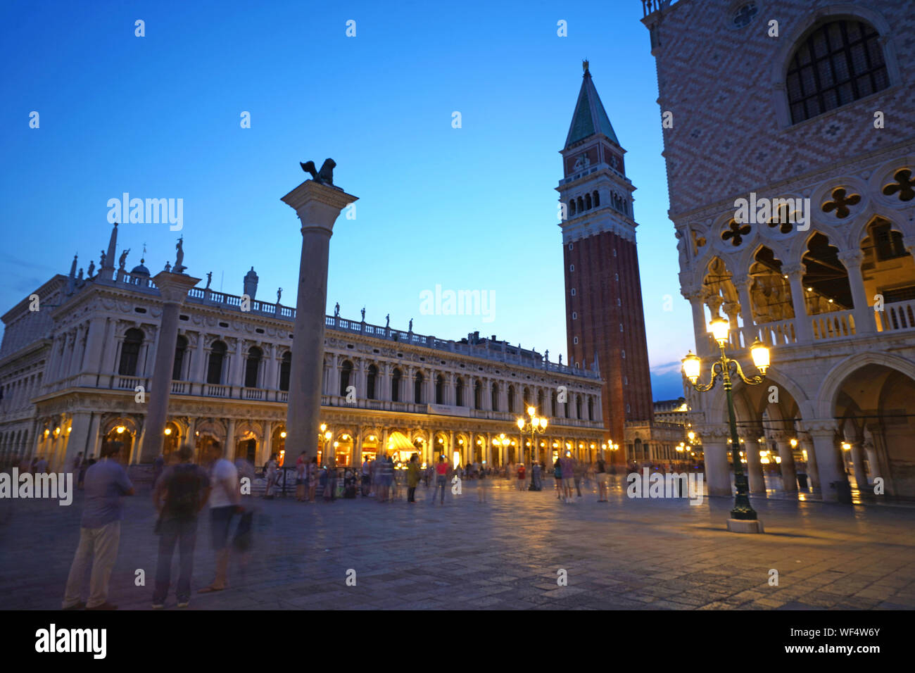 Campanile tower, Piazza San Marco (St. Marks Square) with tourists at twilight, Venice, Veneto, Italy Stock Photo