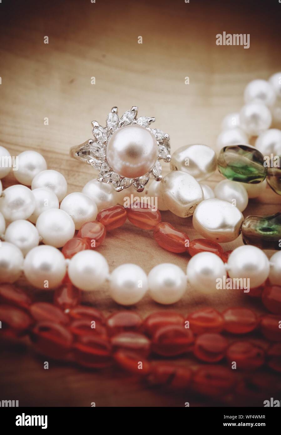 High Angle View Of Pearl Necklace On Table Stock Photo