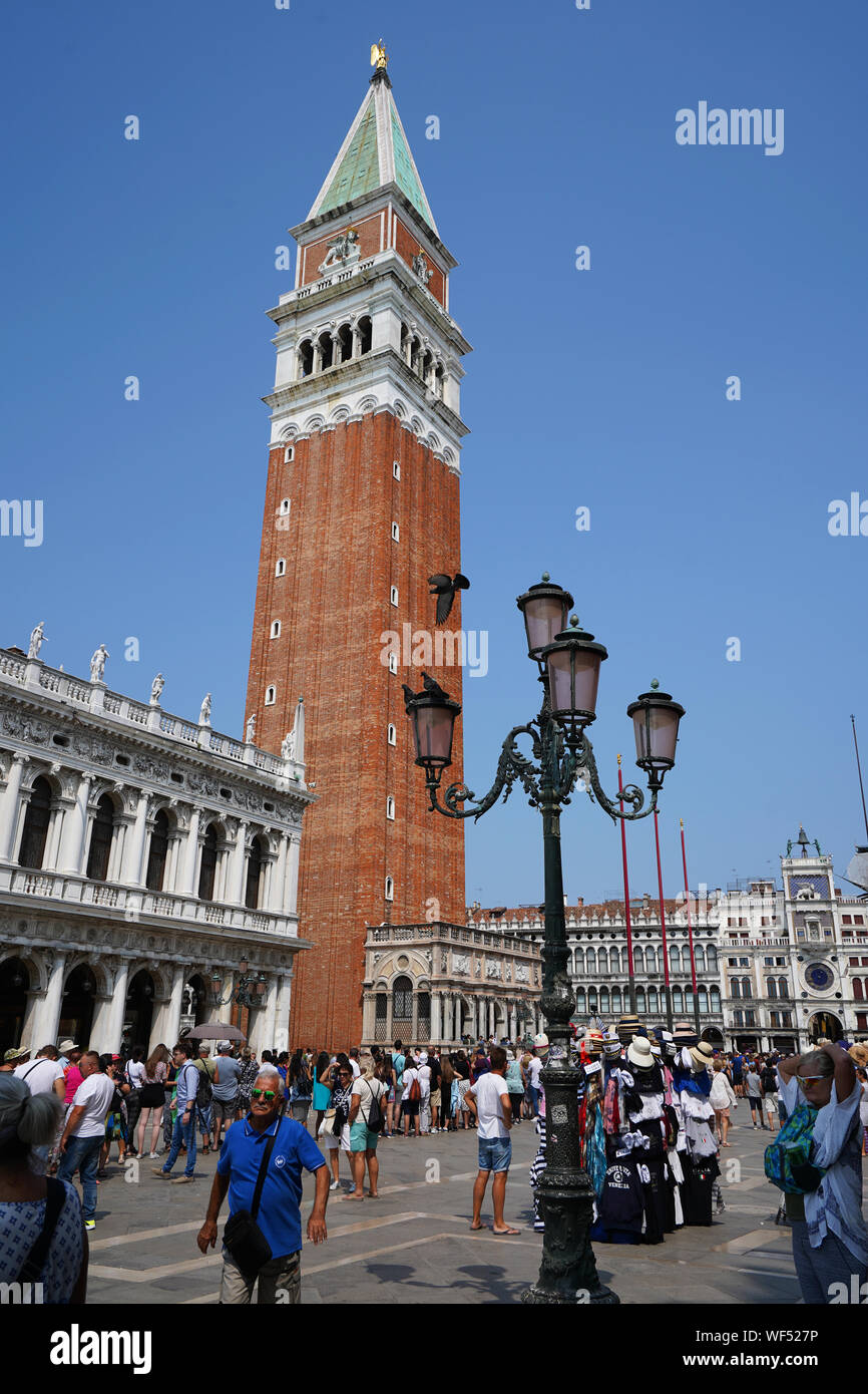 Campanile tower, Piazza San Marco (St. Marks Square) with tourists and Basilica di San Marco, Venice, Veneto, Italy Stock Photo