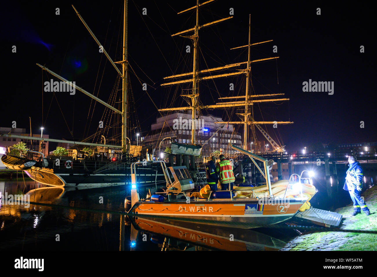 Bremerhaven, Germany. 31st Aug, 2019. The historic sailing ship "Seute Deern" has fallen into a sloping position due to a pump failure. When troops of the fire brigade explored the "Seute Deern", the ship tilted so threateningly that the mission was aborted. The "Seute Deern" (High German "Sweet Girl") belongs to the museum fleet of the German Maritime Museum (DSM) and has been located in the Old Harbour for more than 50 years. Credit: Mohssen Assanimoghaddam/dpa/Alamy Live News Stock Photo