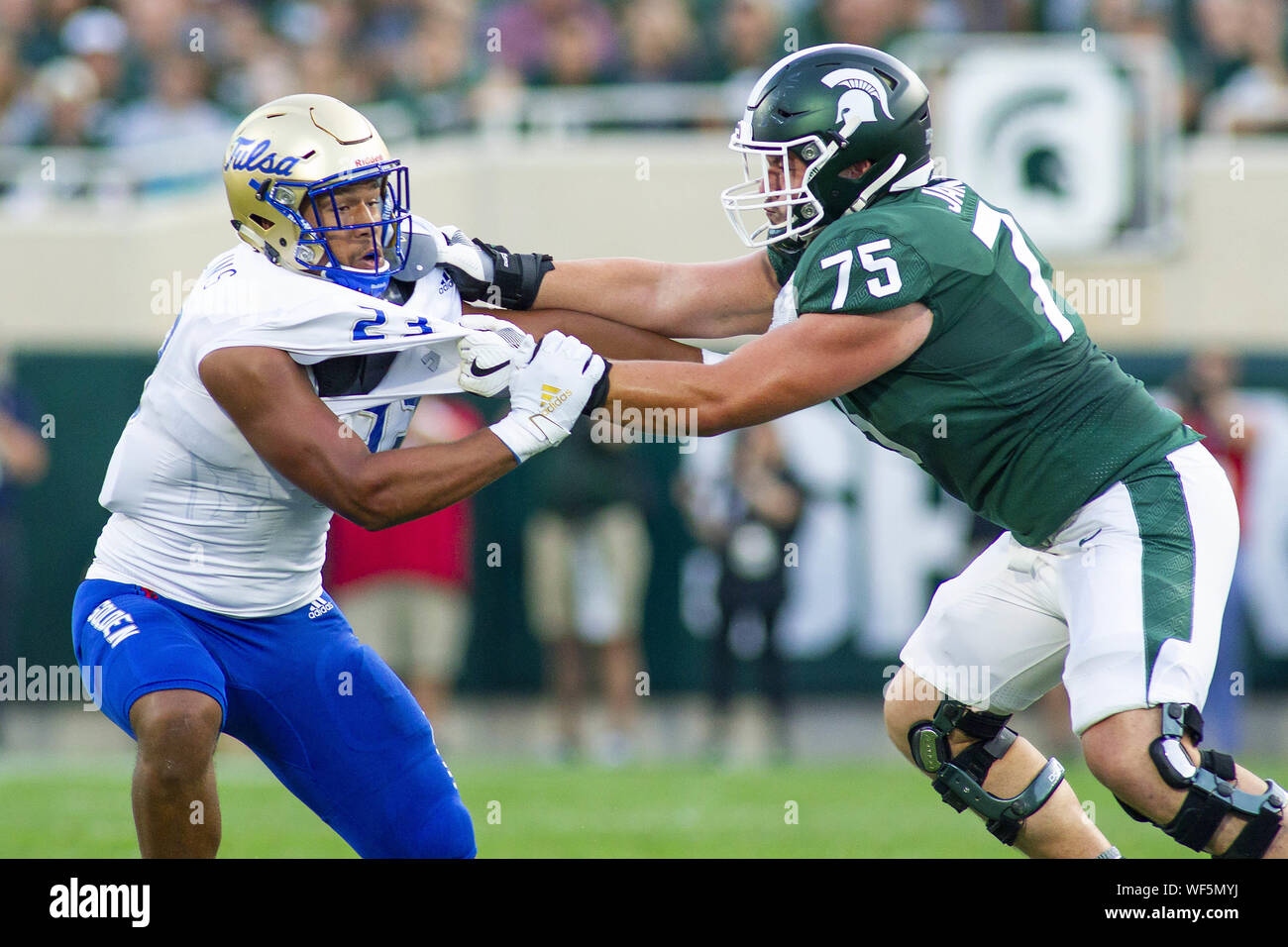 East Lansing, Michigan, USA. 30th Aug, 2019. Michigan State offensive guard KEVIN JARVIS (75) blocks Tulsa linebacker ZAVEN COLLINS (23) during Michigan State's 28-7 victory over Tulsa at Spartan Stadium. Credit: Scott Mapes/ZUMA Wire/Alamy Live News Stock Photo