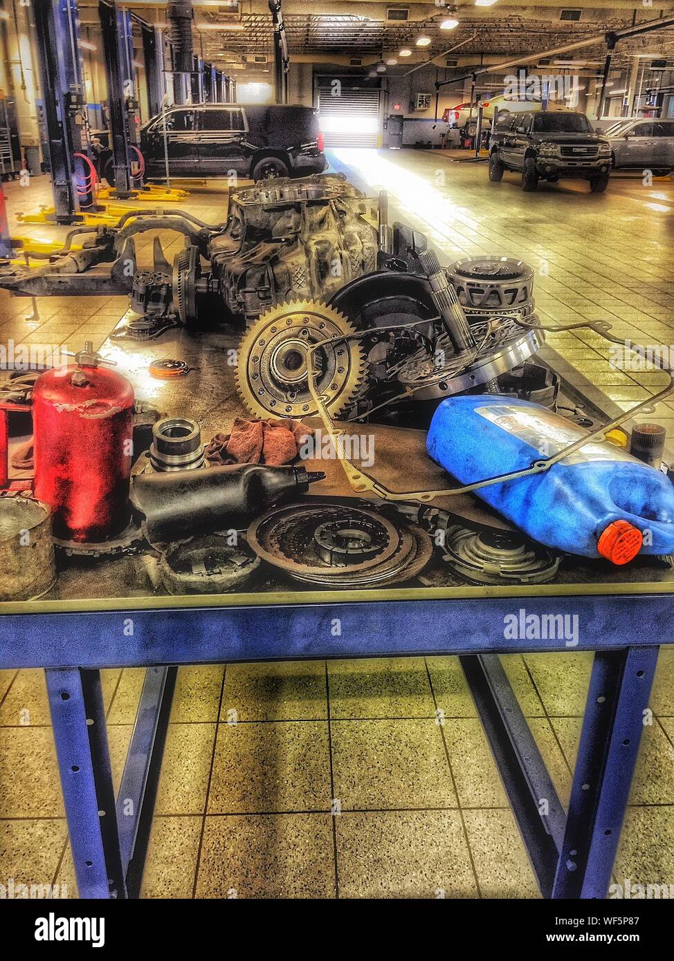 Vehicle Parts With Containers On Workbench In Auto Repair Shop