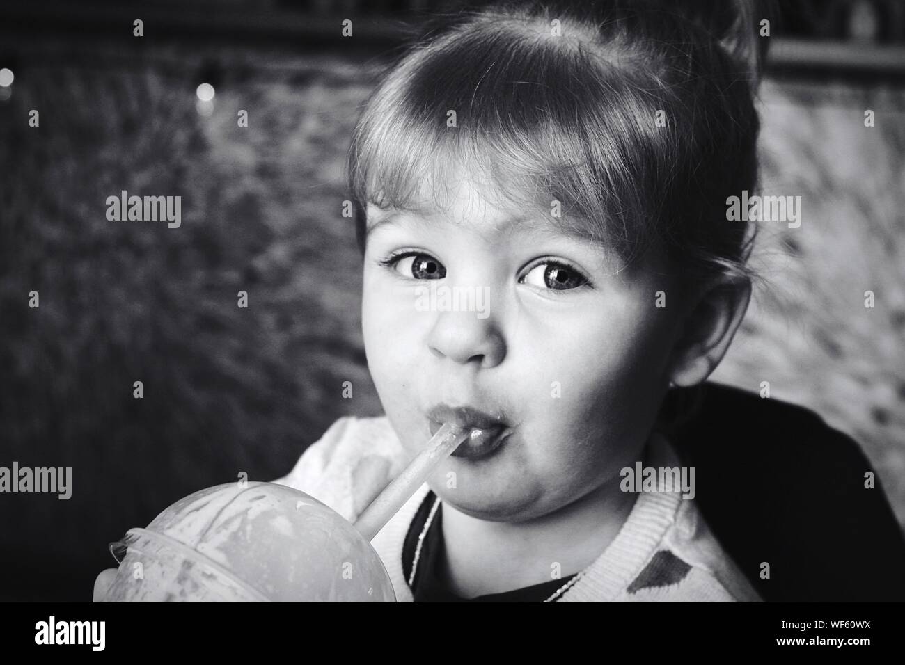 Close-up Portrait Of Girl Sipping Drink Stock Photo