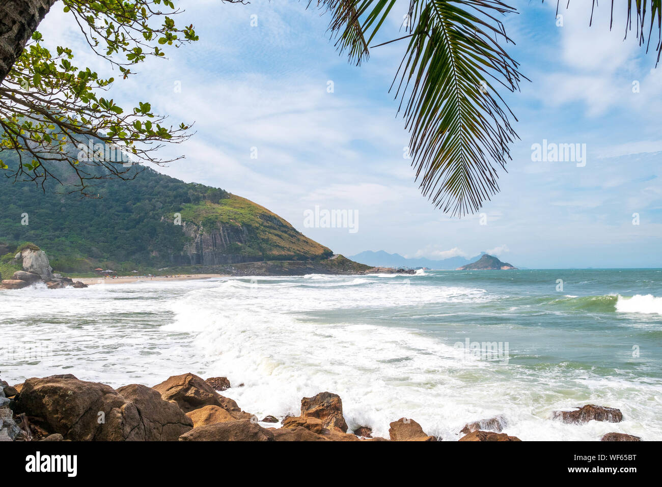 Landscape at Prainha Beach, Rio de Janeiro, on a windy day with the sea full of waves Stock Photo