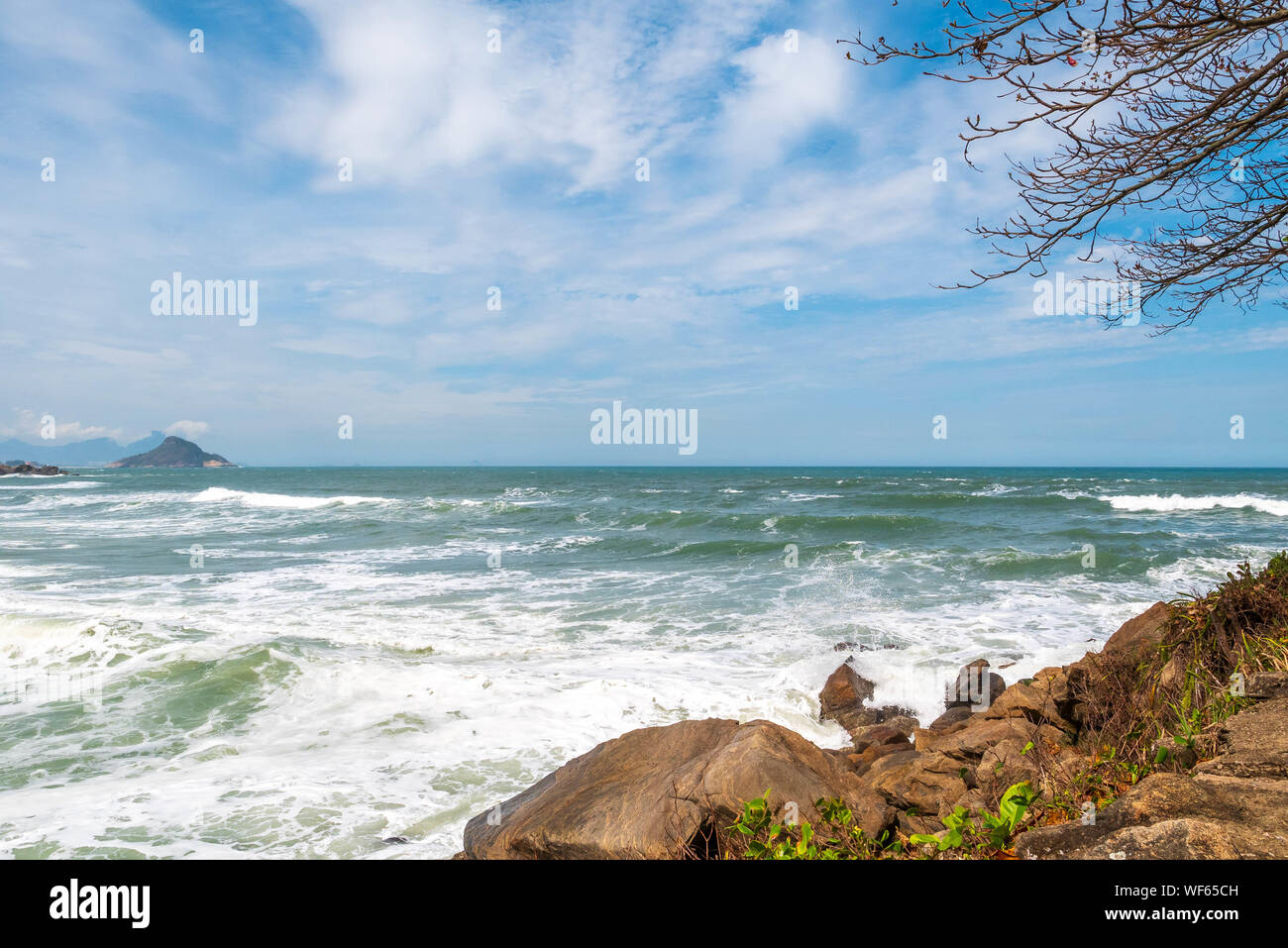 Landscape at Prainha Beach, Rio de Janeiro, on a windy day with the sea full of waves Stock Photo