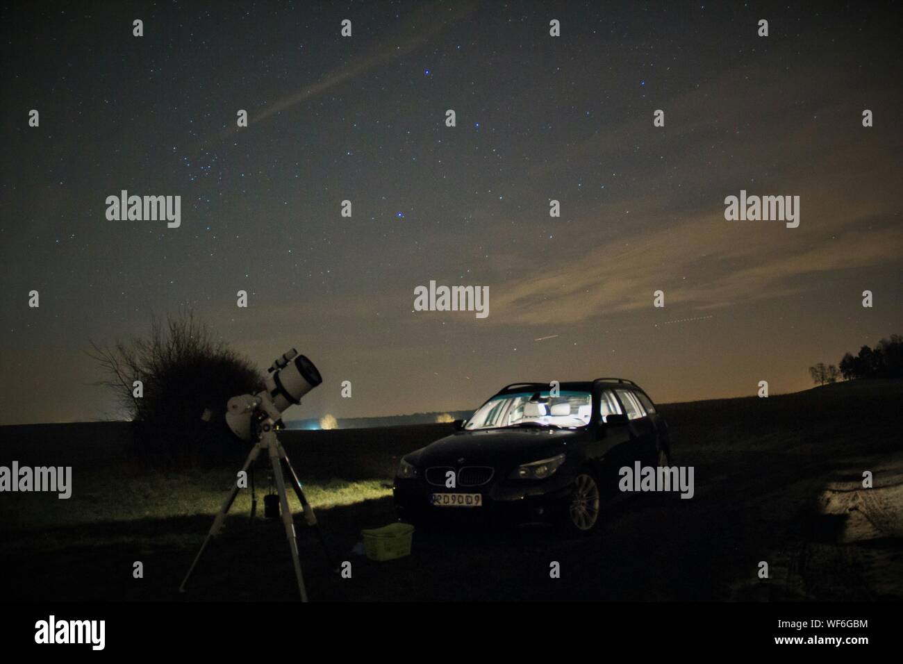 Astrophotography Setup And Car On Landscape Against Night Sky Stock Photo