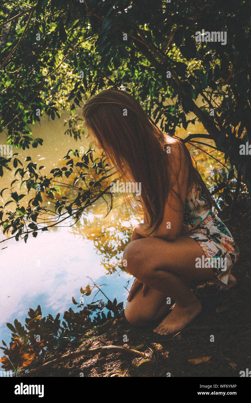Woman kneeling outdoors hi-res stock photography and images - Alamy