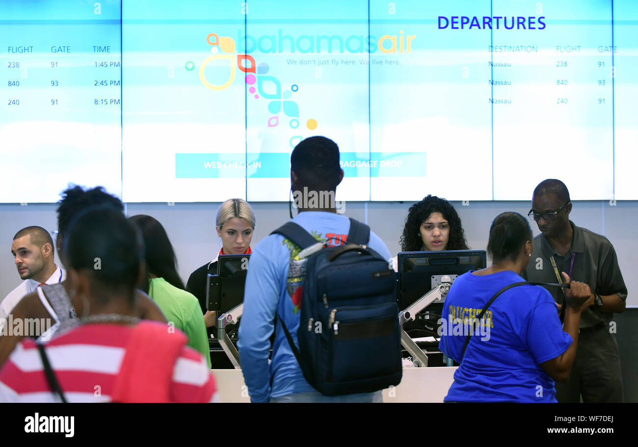 Orlando, Florida, USA. 30th Aug, 2019. Passengers check in at the Bahamas Air ticket counter at Orlando International Airport for departing flights to the Bahamas ahead of the arrival of Hurricane Dorian. The hurricane has intensified to Category 4 and will threaten parts of the Bahamas and the Southeastern U.S. over Labor Day weekend. Credit: Paul Hennessy/SOPA Images/ZUMA Wire/Alamy Live News Stock Photo