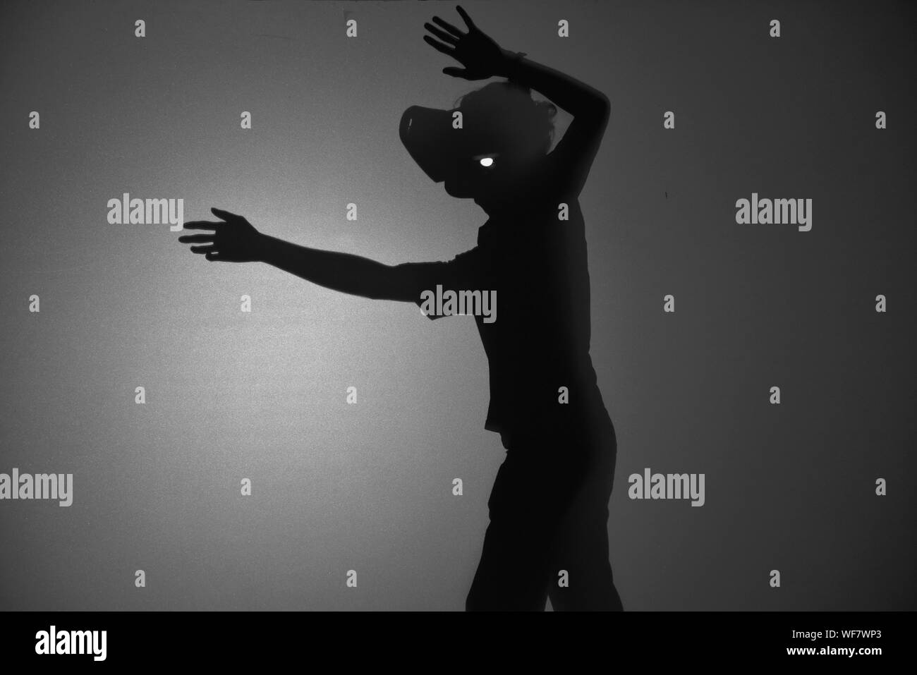 Shadow man one arm raised hi-res stock photography and images - Alamy
