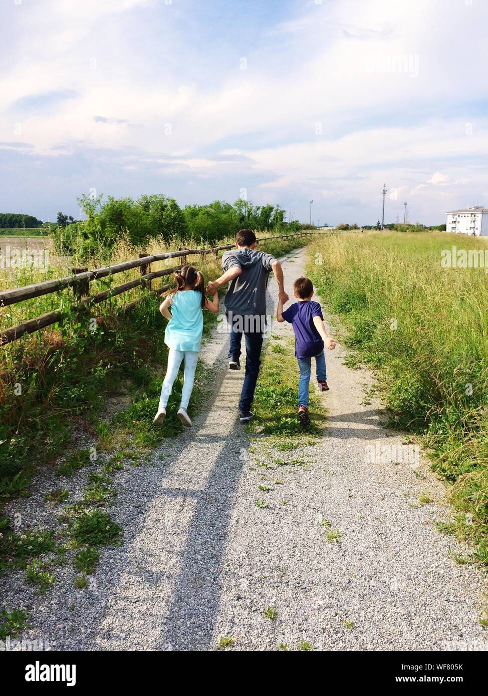 Children holding hands running hi-res stock photography and images - Alamy