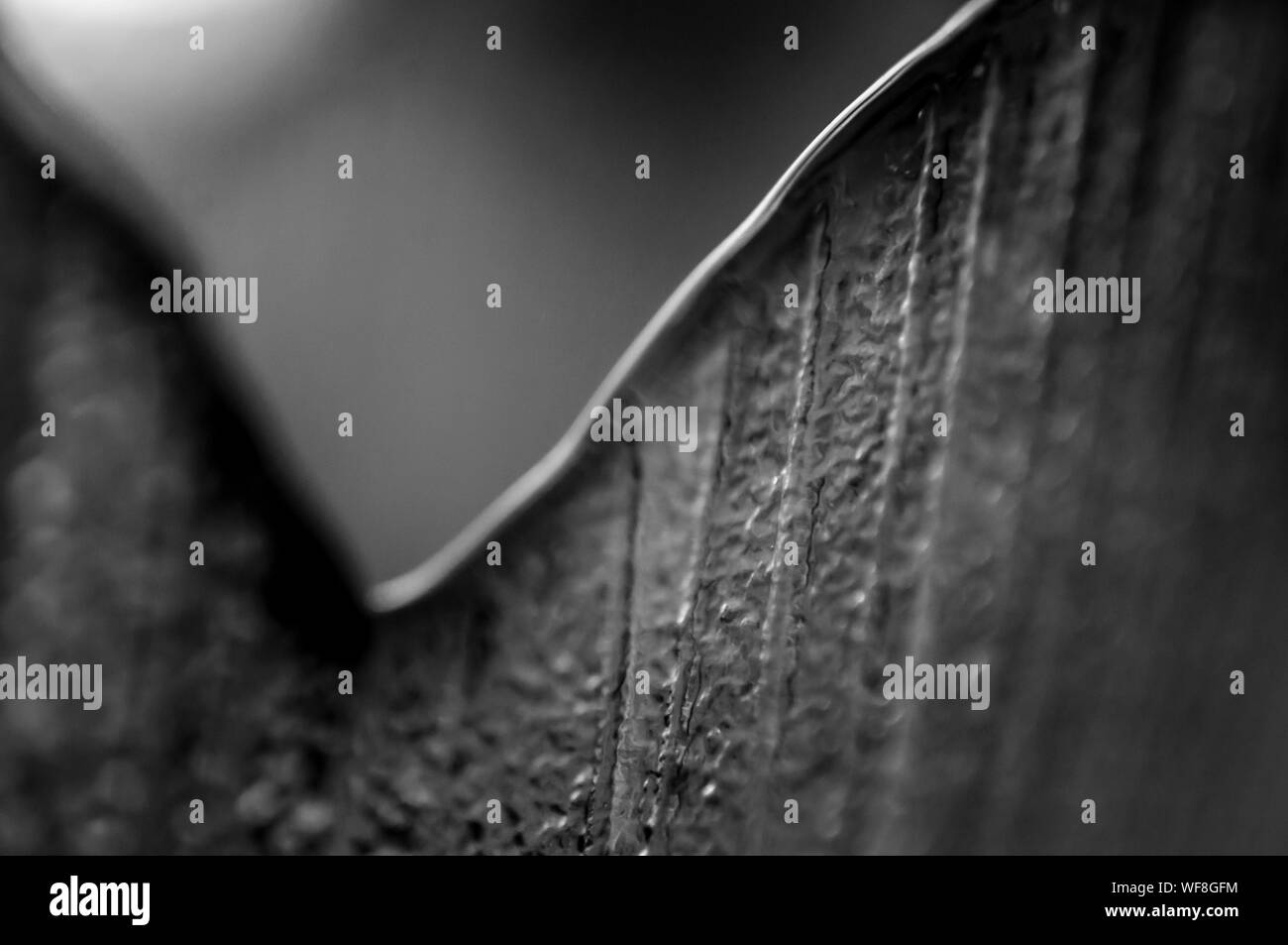 Macro of a smooth and rough metallic edge Stock Photo