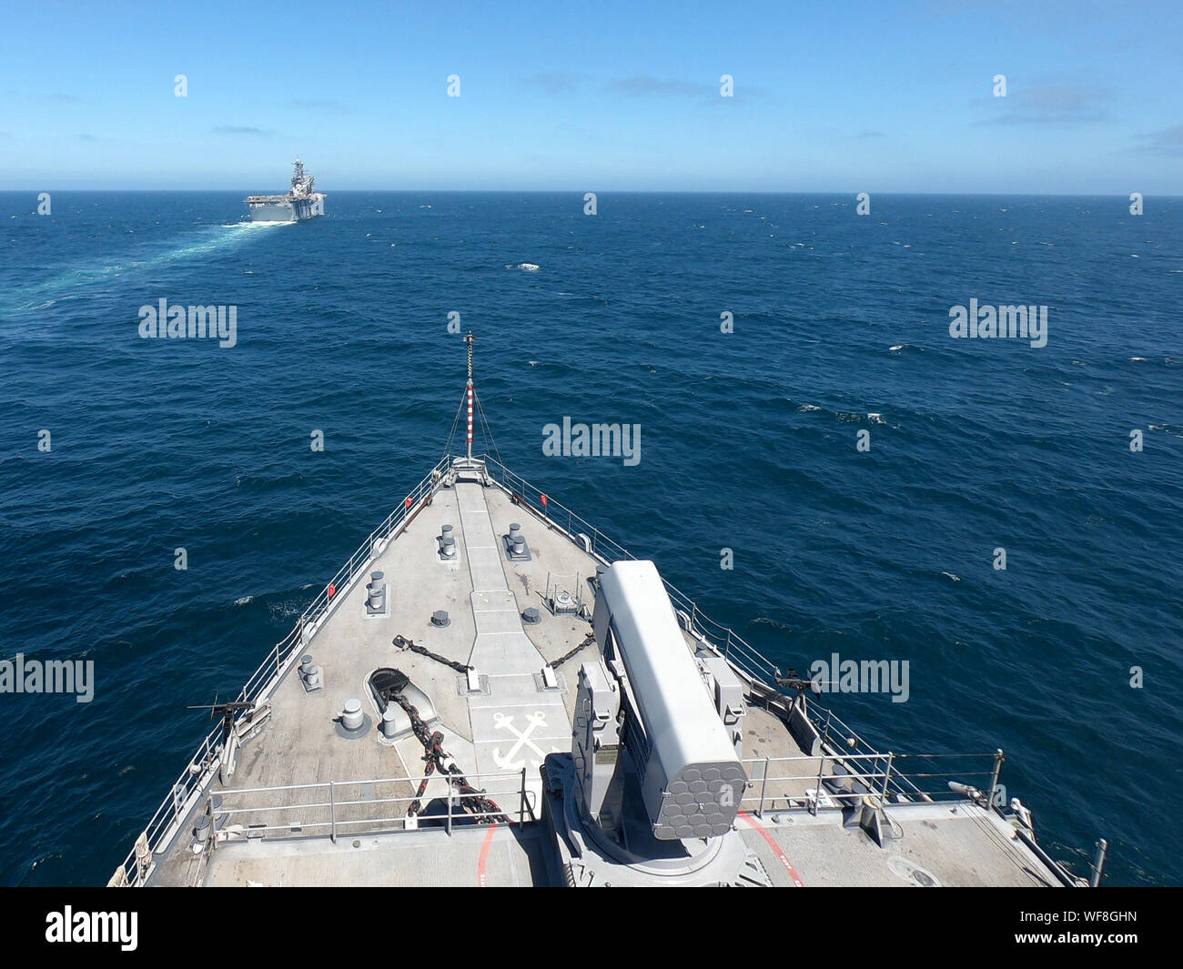 190820-N-XN177-0198 PACIFIC OCEAN (Aug. 20, 2019) –The dock landing ship USS Comstock (LSD 45) prepares to come along side amphibious assault ship USS America (LHA 6) during a replenishment at sea evolution. Comstock is currently underway conducting routine operations. This year USS Comstock will participate in the U.S. Navy Fleet Week in Los Angeles. (U.S. Navy Photo by Mass Communication Specialist 1st Class Peter Burghart/Released) Stock Photo