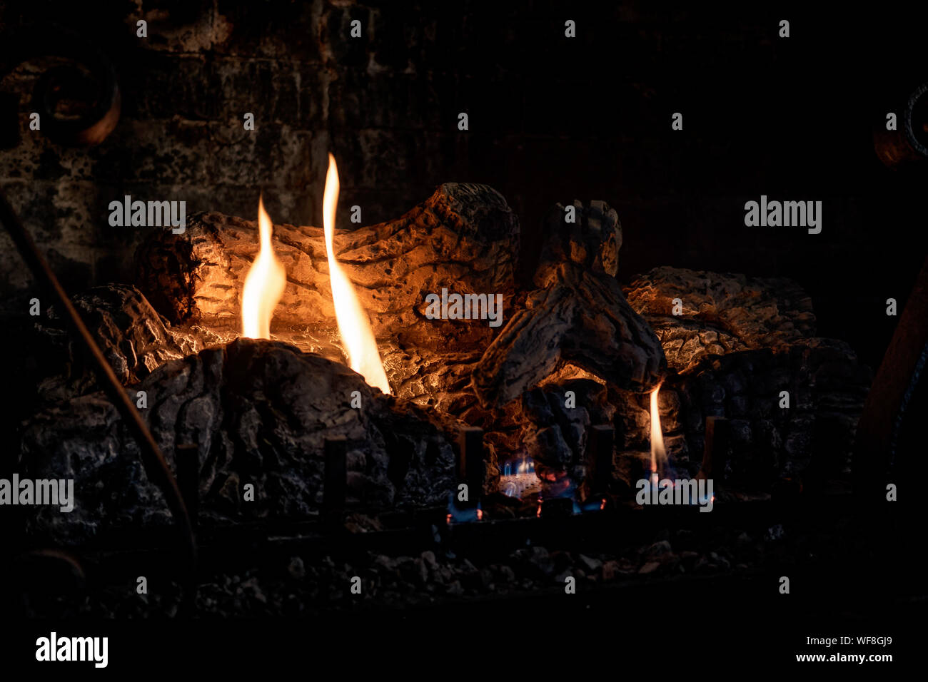 Cozy fireplace with burning logs Stock Photo - Alamy