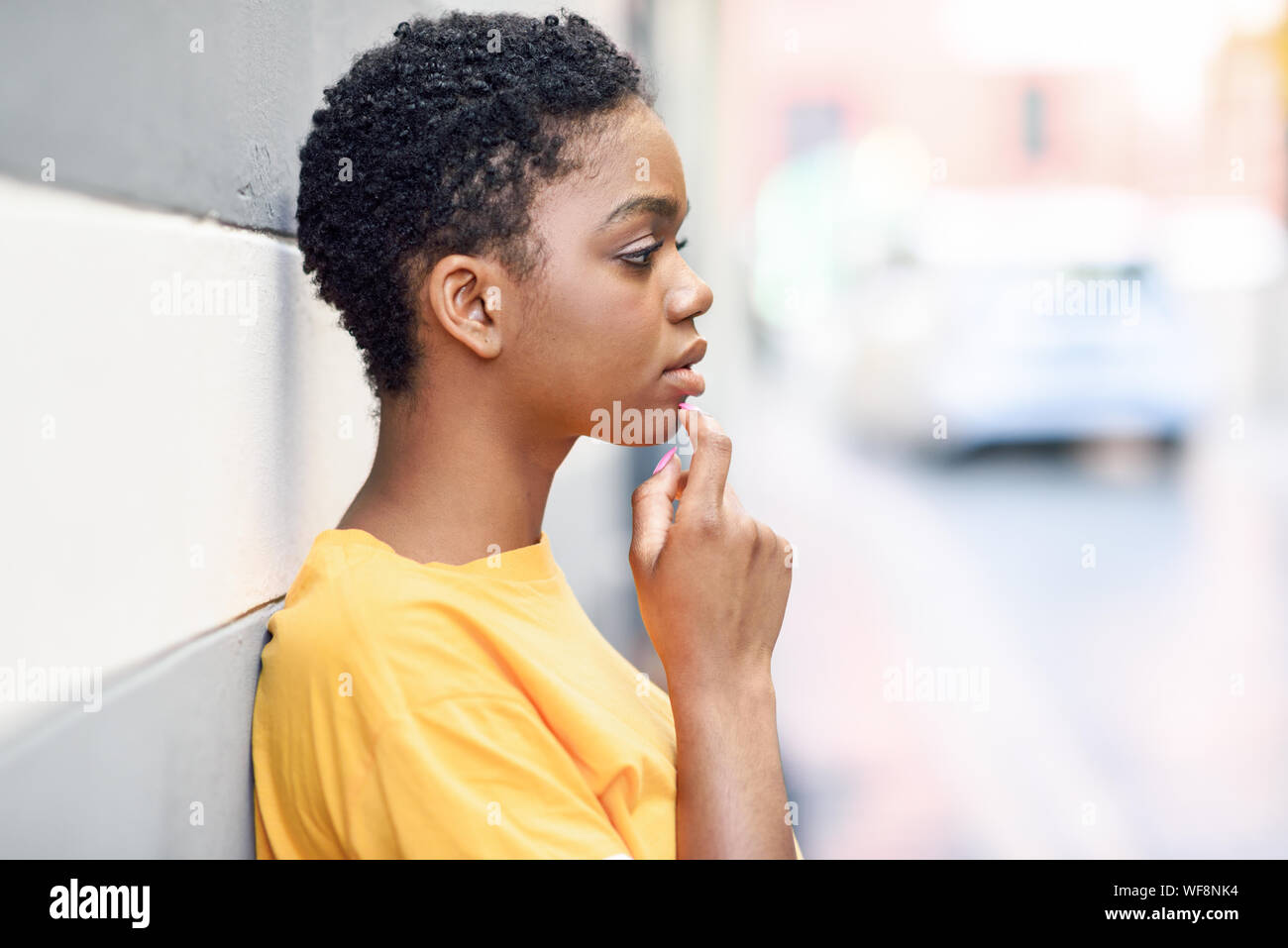 Thoughtful black woman with sad expression outdoors. Stock Photo