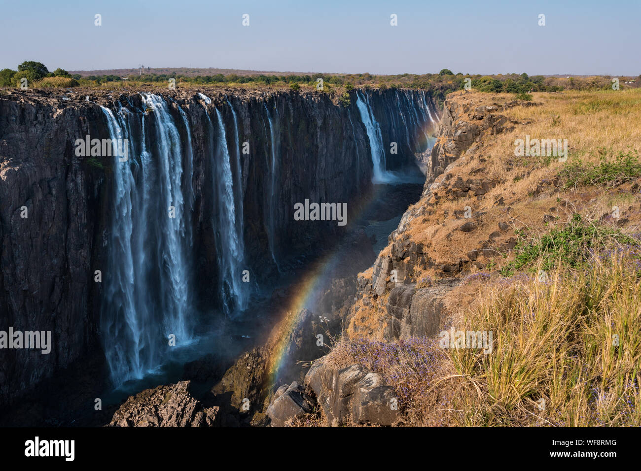Victoria Falls and Gorge with Rainbow, Zambezi River, between Zimbabwe and Zambia, Africa Stock Photo