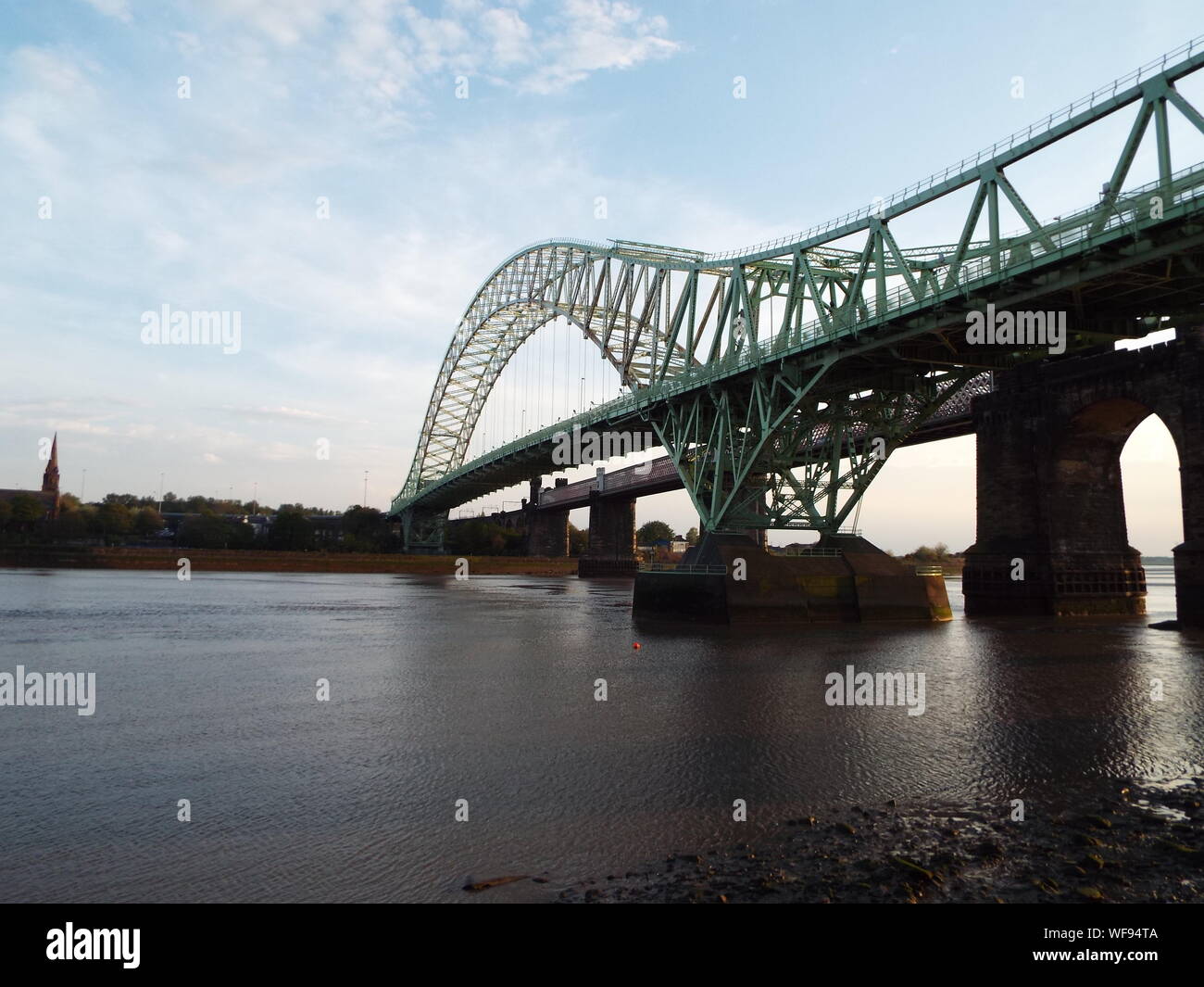 Low Angle View Of Silver Jubilee Bridge Over River Against Sky On Sunny Day Stock Photo