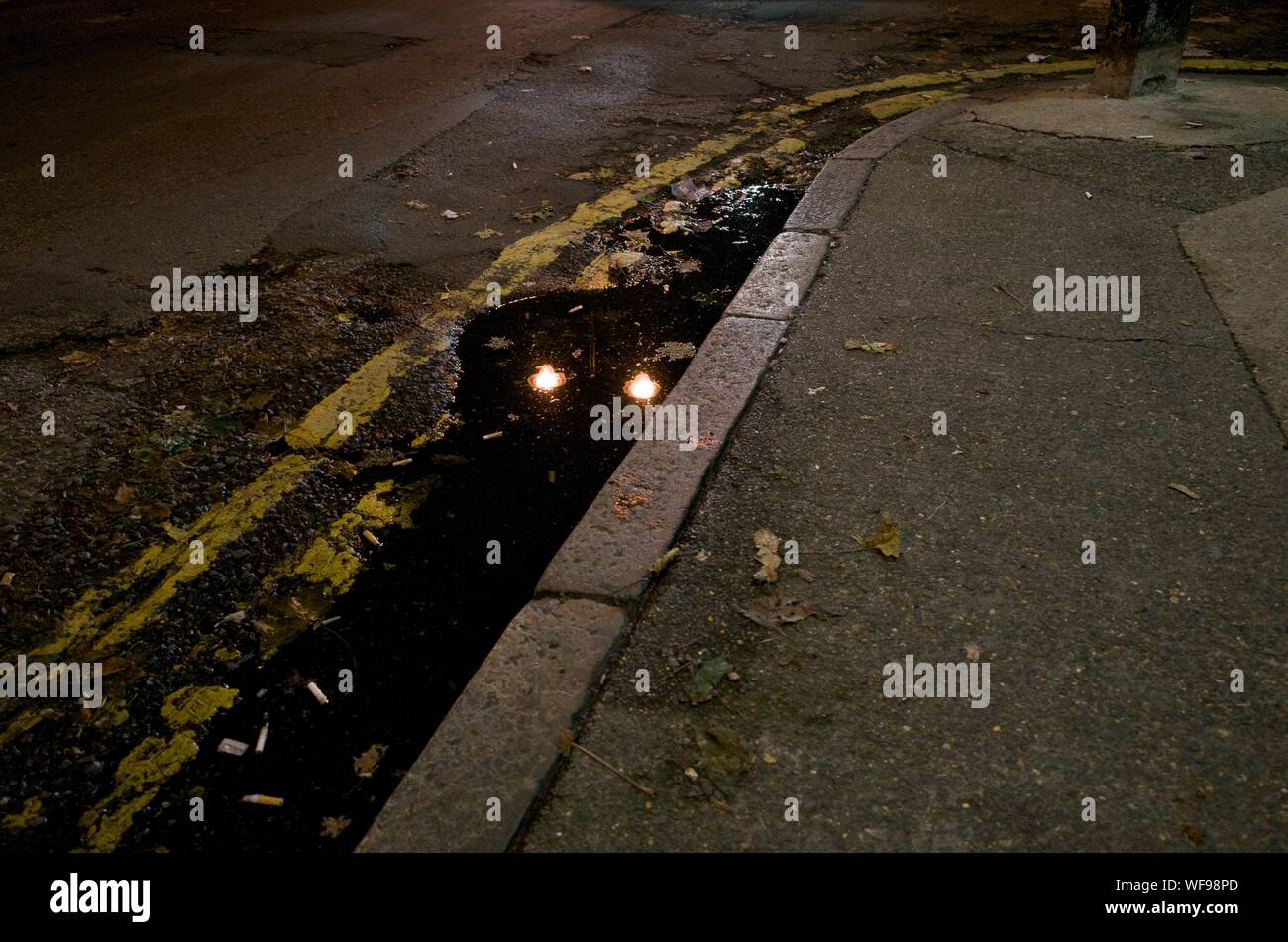 View Of Sidewalk With Dirty Water Stock Photo