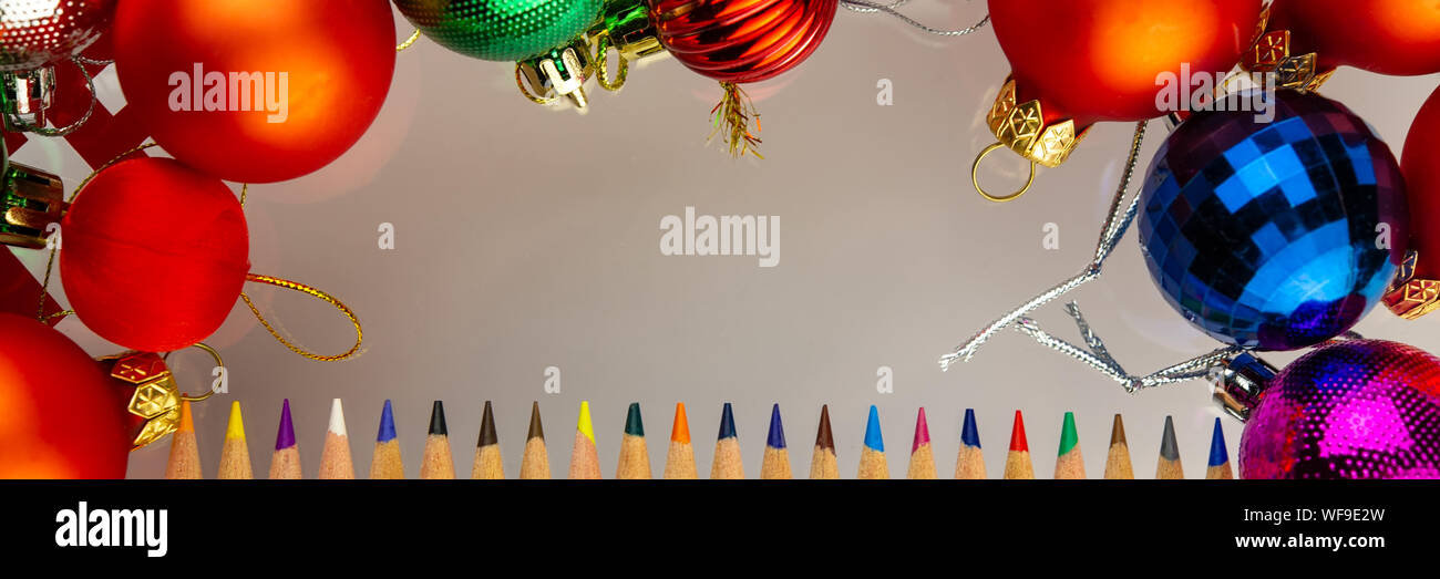 Colored Pencils And Multicolored New Year S Toys Balls Lying