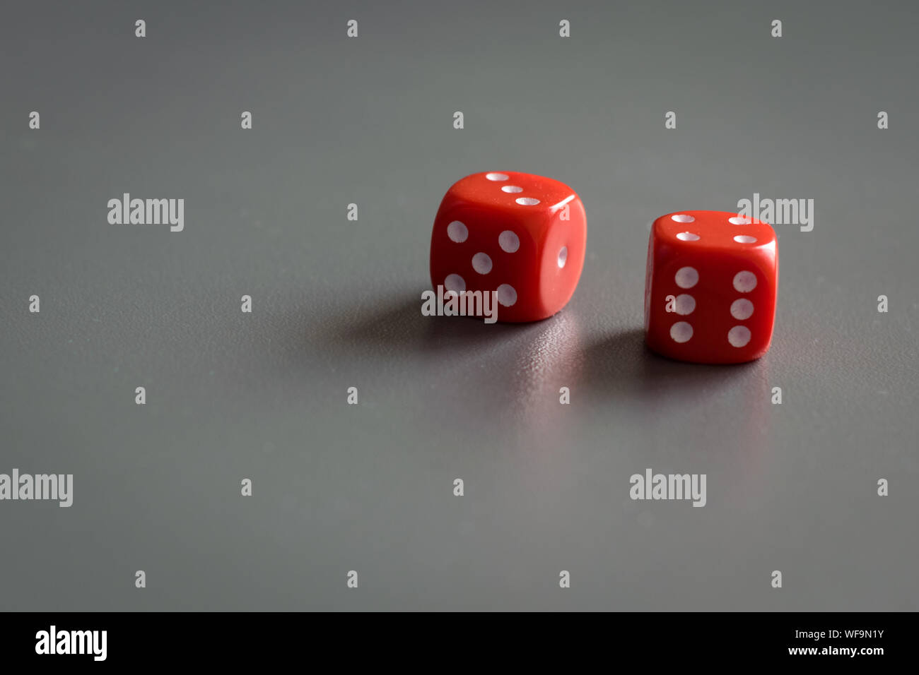 Two red dice isolated on grey background Stock Photo