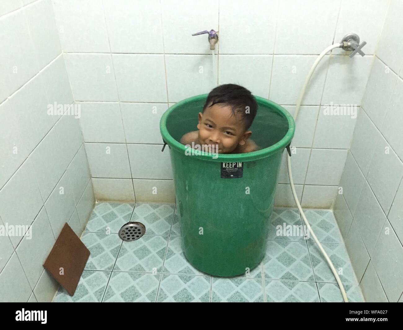 Happy Boy In Bucket In Bathroom Stock Photo Alamy