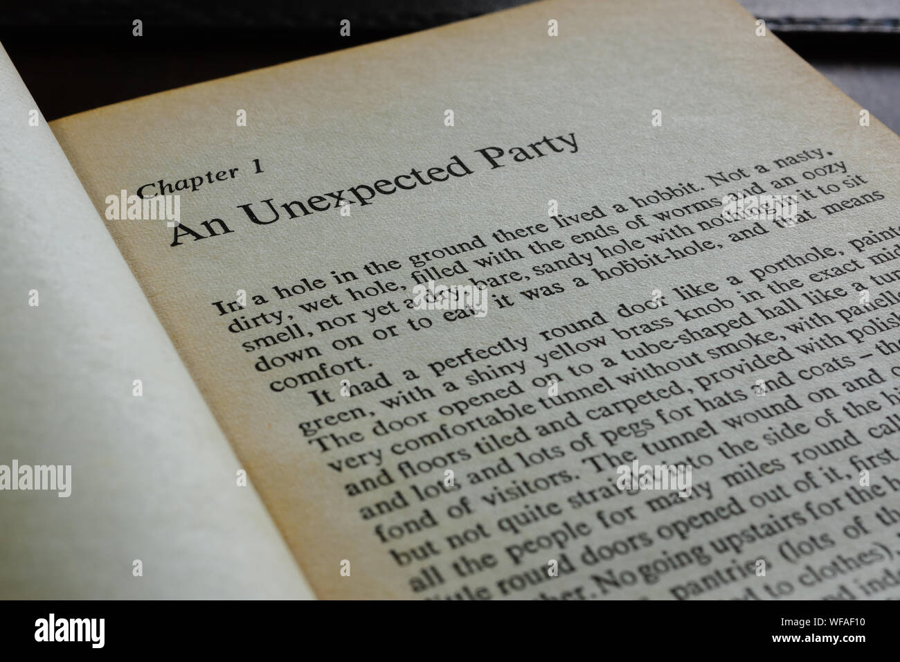 A vintage paperback showing the opening chapter of The Hobbit an unexpected party written by J.R.R. Tolkien in 1937 Stock Photo