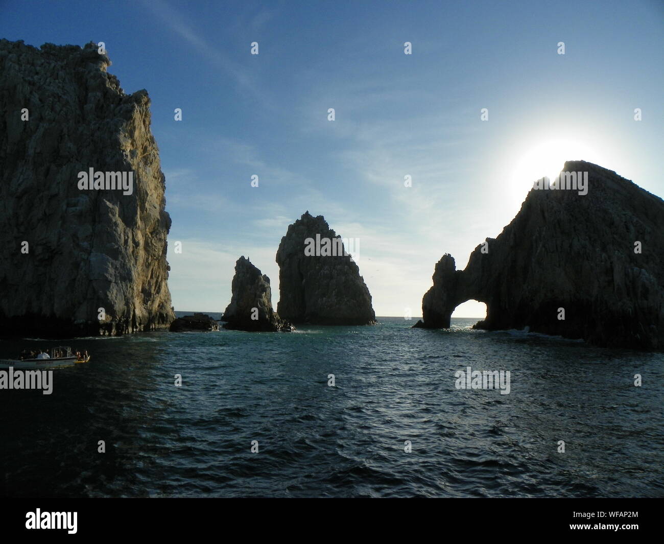 Arch Of Cabo San Lucas And Rock Formation In Sea Against Sky Stock Photo
