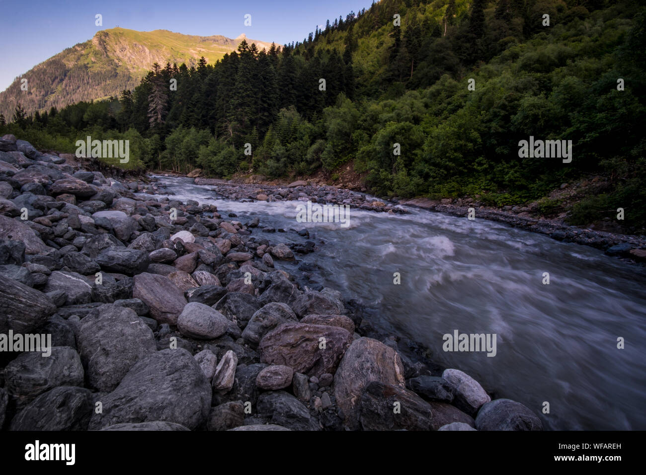 rushing blue river in a mountain forest. Mountain landscape. North ...