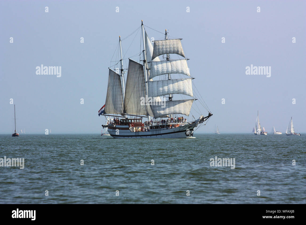 Sailing in a tall ship in Volendam sea is compelling because it is uncontrived, springing spontaneously from the voyage itself. Stock Photo