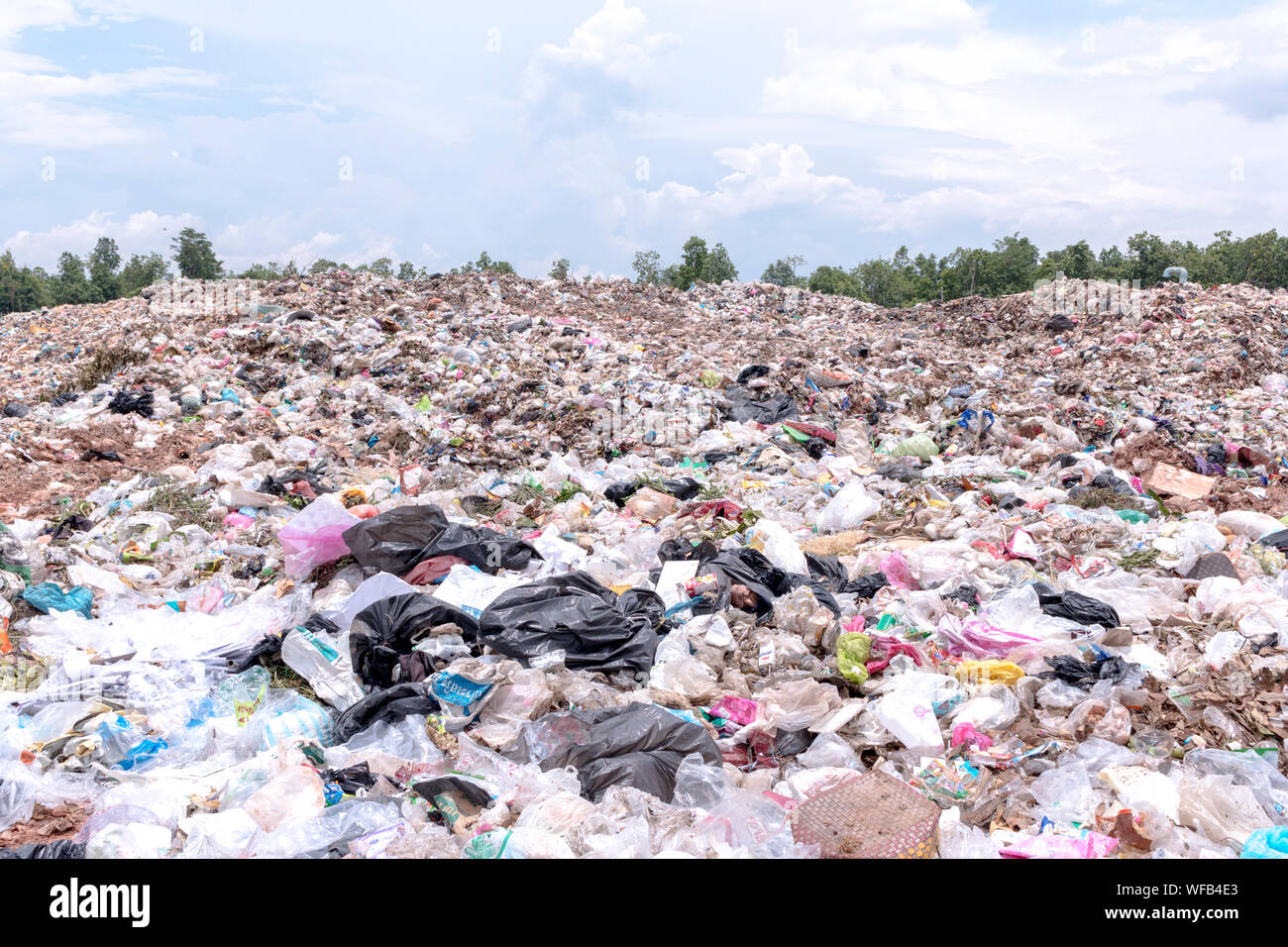 Land Of Garbage At Junkyard Against Sky Stock Photo