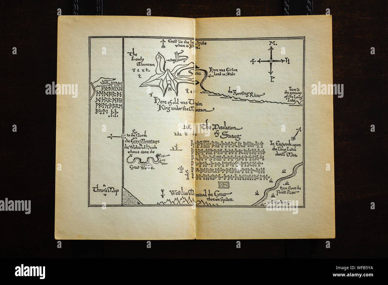 A vintage paperback showing Thror's Map in The Hobbit detailing the lonely mountain and the desolation of Smaug. Written by J.R.R. Tolkien Stock Photo