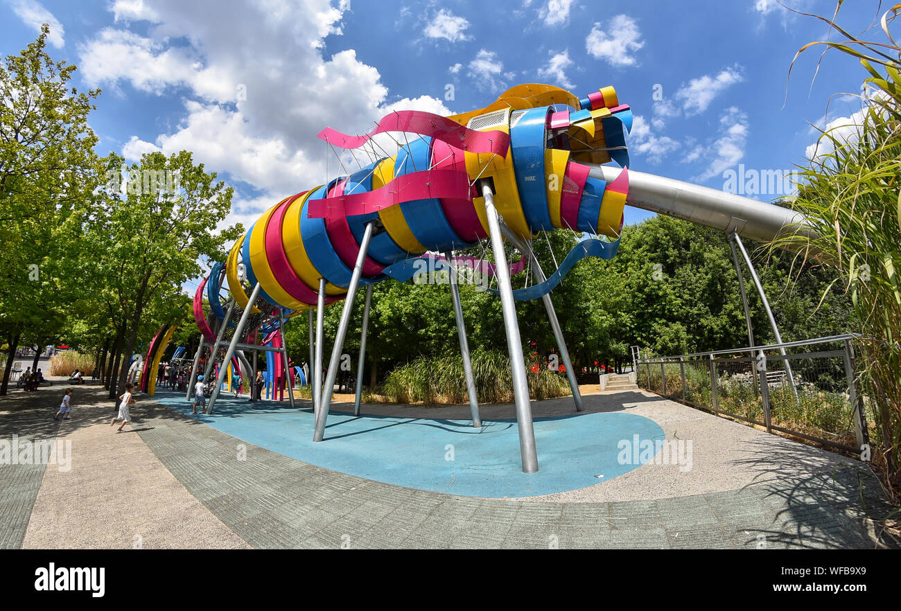 PARIS, FRANCE - JULY 24, 2018: The garden of Dragon is a free play area for children in Parc de la Villette. The colorful Dragon slide, made of steel, Stock Photo