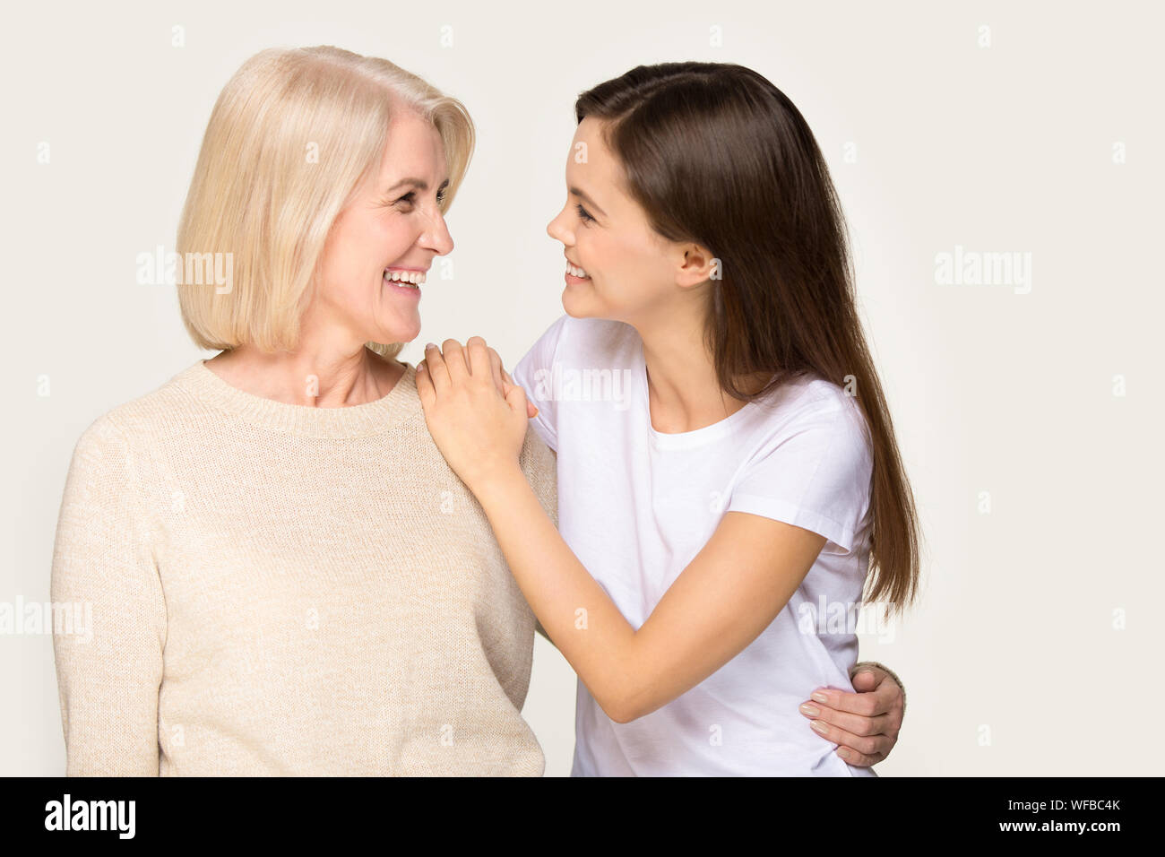 Smiling senior mother and grownup daughter hugging Stock Photo