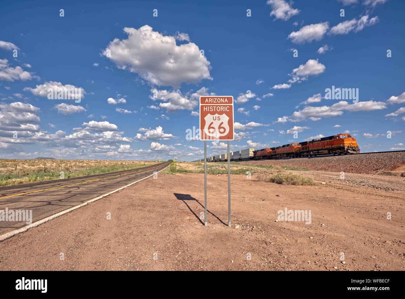 Train driving past a Historic Route 66 sign near Seligman, Arizona, United States Stock Photo