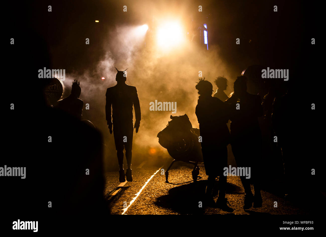 Street artists are silhouetted during a performance of Bivouac by French street arts G??n??rik Vapeur, one of the headlining performances at the Freedom Festival in Hull. Stock Photo
