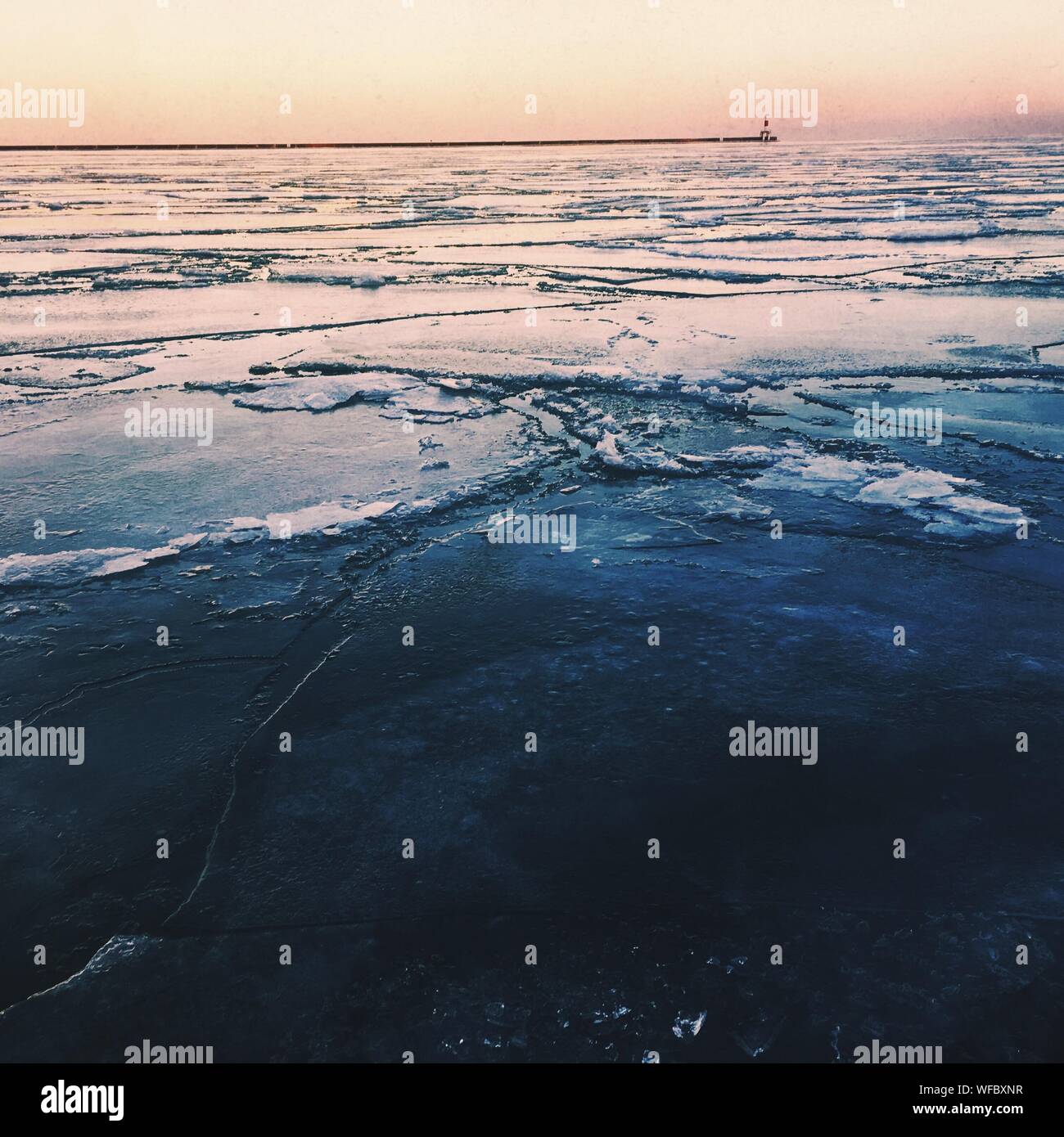 Scenic View Of Frozen Sea Against Sky During Sunset Stock Photo