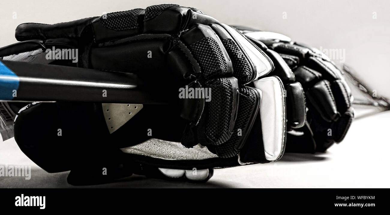 Hockey gloves and stick on white background Stock Photo - Alamy