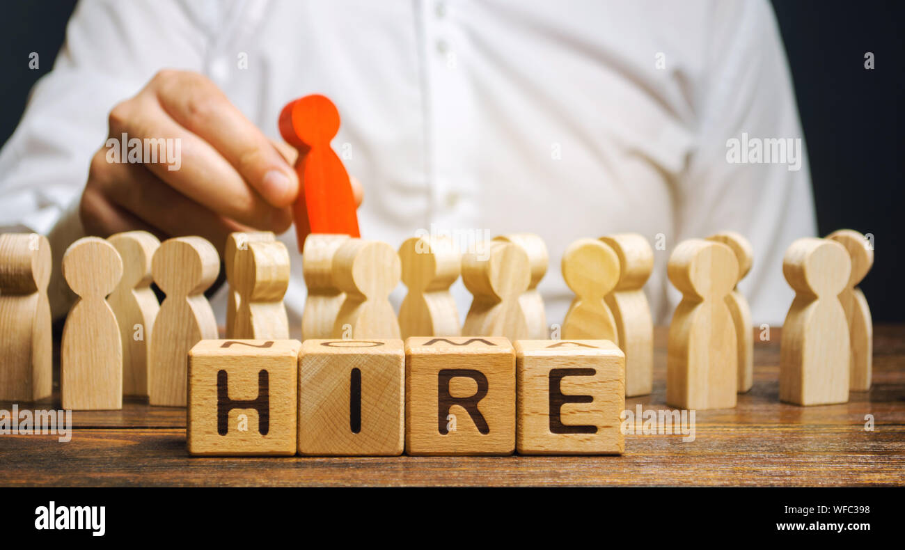 Wooden blocks with the word Hire. Headhunter selects a person from the crowd. Human Resource Management. Recruiting Headhunting. Hiring employees. Bus Stock Photo
