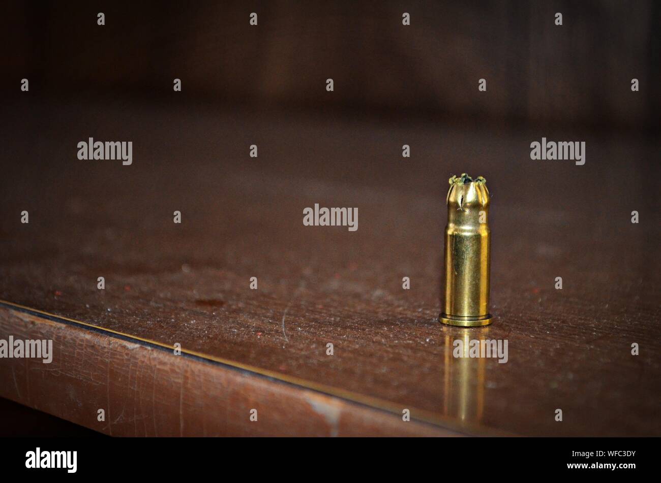 Close-up Of Gold Bullet Casing On Table Stock Photo