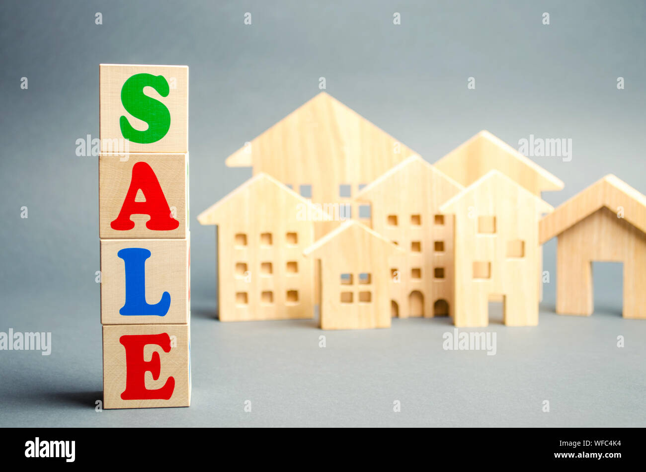 Wooden Blocks With The Word Sale And Wooden Miniature Houses The