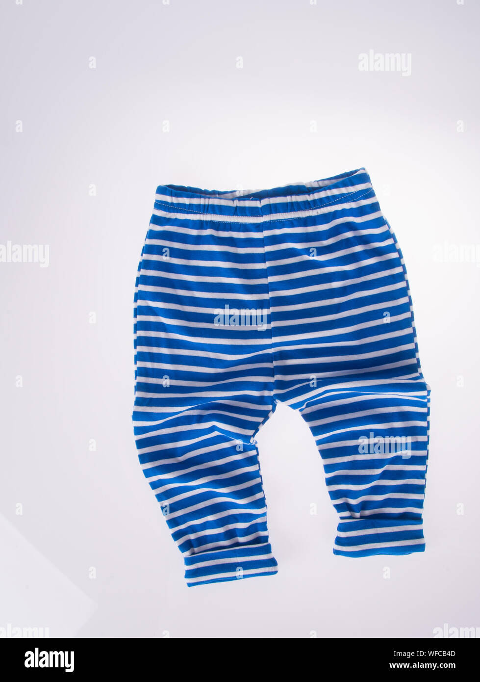 Close-up Of Blue Striped Pajamas Over White Background Stock Photo