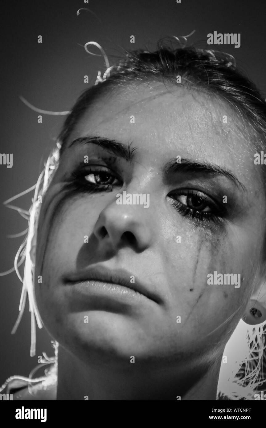 Portrait Of Sad Woman With Smudge Eye Make-up Stock Photo