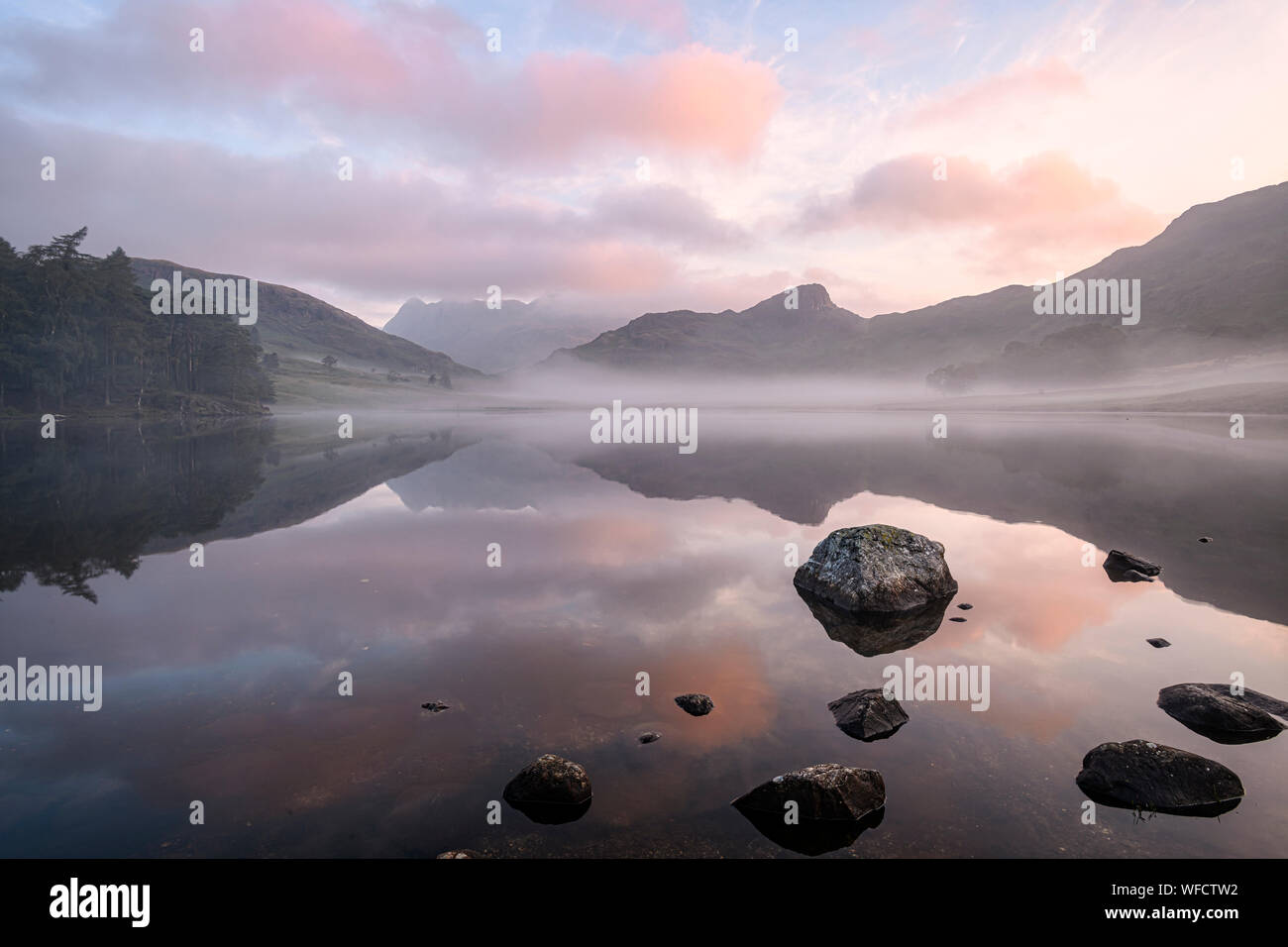Lovely misty late summer sunrise at Blea Tarn in the Lake District Stock Photo