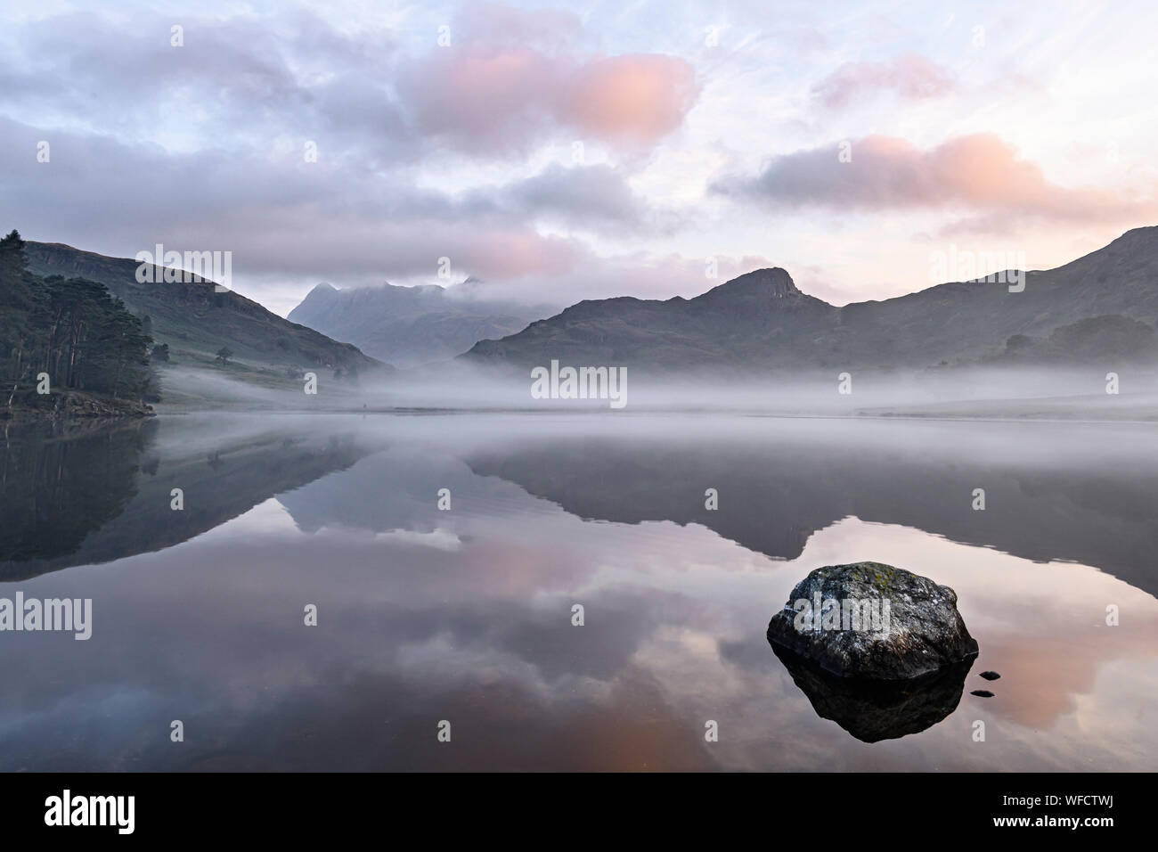 Late summer misty sunrise at Blea Tarn in the Lake District Stock Photo