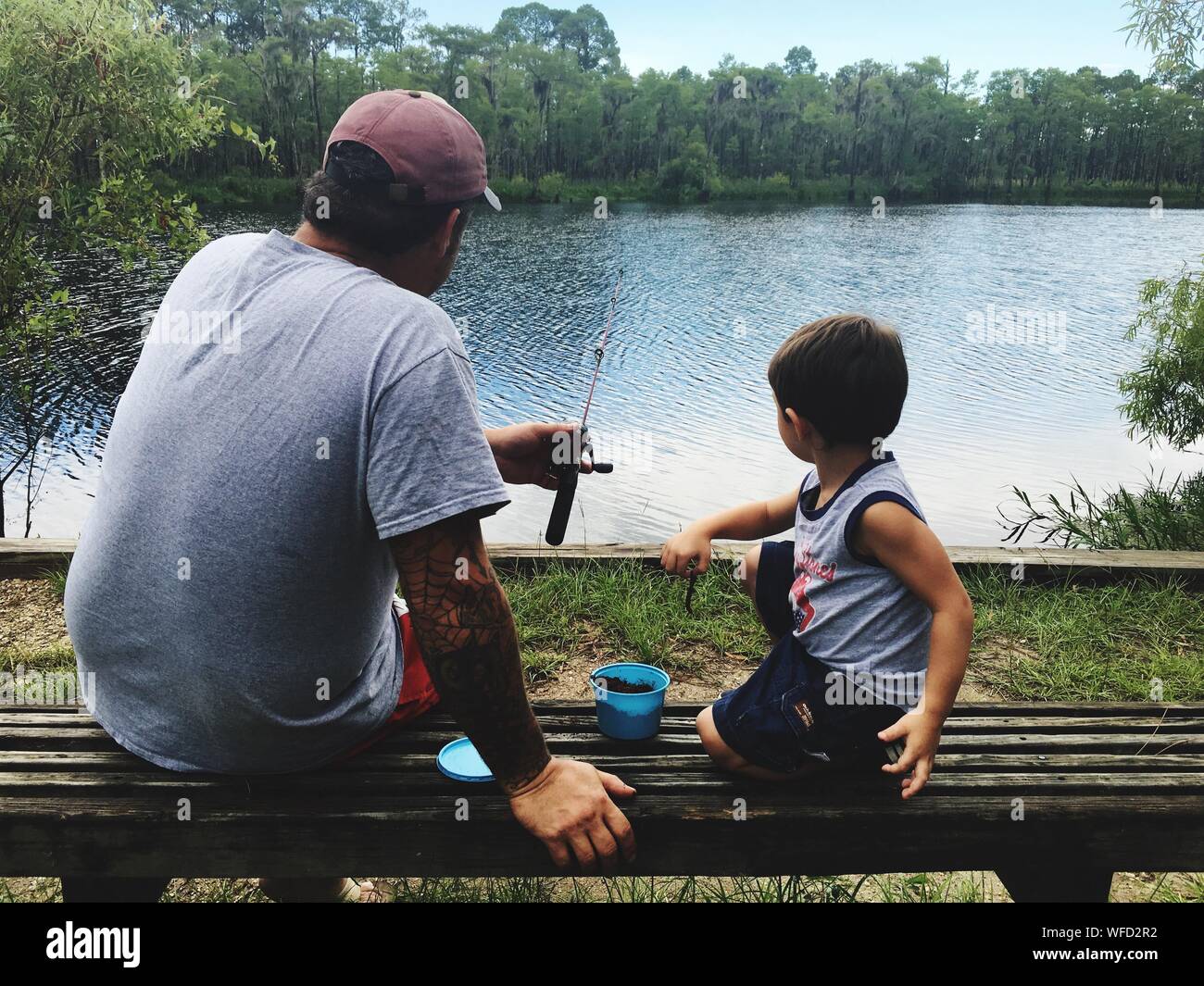 Two boys sitting fishing hi-res stock photography and images - Alamy