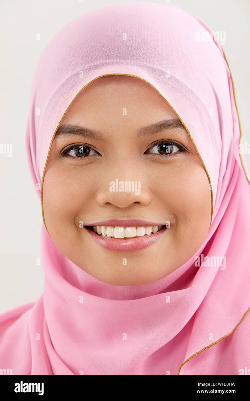 close up of malay woman with tudung looking at camera Stock Photo